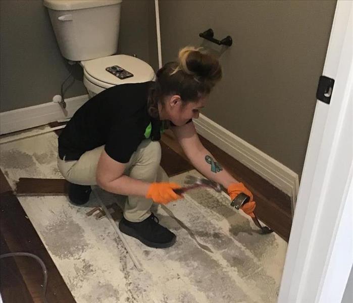 employee removing flooring
